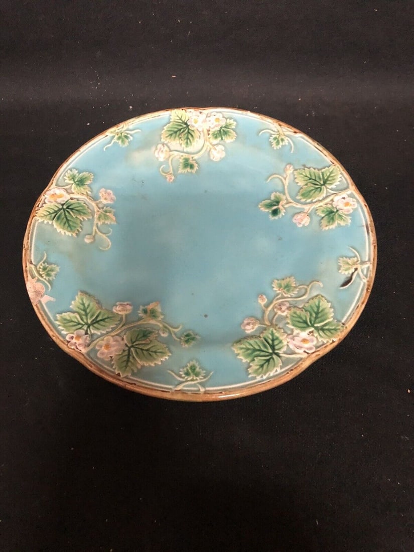 George Jones Majolica Plate: It measures 8 1/4” and has the jones mottling and bare spot with the stock number on the back. It has a small flake on the front rim. Otherwise it has no other issues. Shipping: Domestic: Flat-r