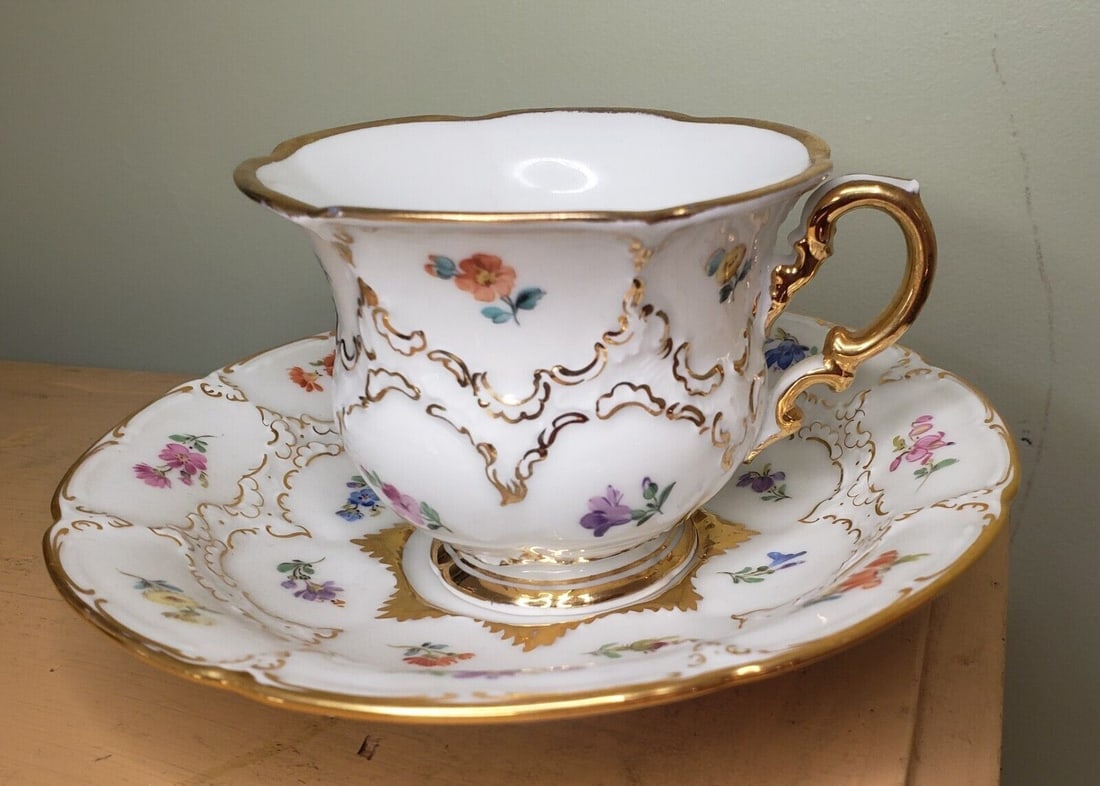 Meissen Cup And Saucer demitasse colorful: Beautiful piece in fair condition. Third chips in base of cup. Piece measures 3 " tall and saucer 6" diameter. Shipping includes insurance. Shipping: Domestic: Flat-rate of $17.00 to anywhere within t