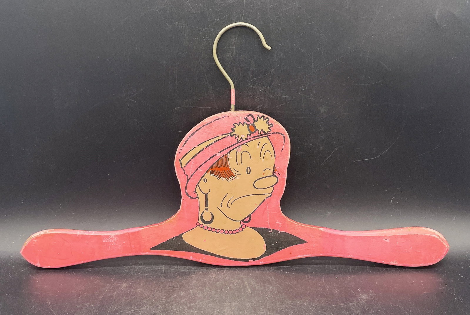 1922 MAGGIE BRINGING UP FATHER COMICS WOOD CLOTHES HANGER: Title: 1922 MAGGIE BRINGING UP FATHER COMICS WOOD CLOTHES HANGER Date/Period: 1922 Materials: wood Dimensions: 15" long Additional Information: 1923 MAGGIE BRINGING UP FATHER COMICS WOOD CLOTHES HANGE
