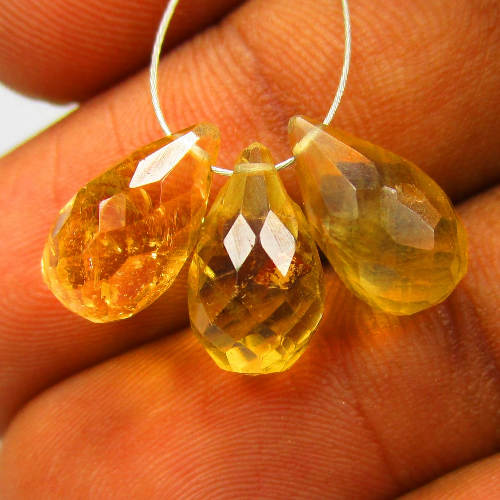 9.10 Ctw Natural 3 Citrine Drilled Pear Drop Beads: No Reserve! Title: 9.10 Ctw Natural 3 Citrine Drilled Pear Drop Beads Stone Clarity: Transparent Gemstone:Natural Citrine Beads Carat Weights: 9.1 Size/Dimensions: 11.4x6.5 - 11.9x6.9 mm / 3 Pc's Addi