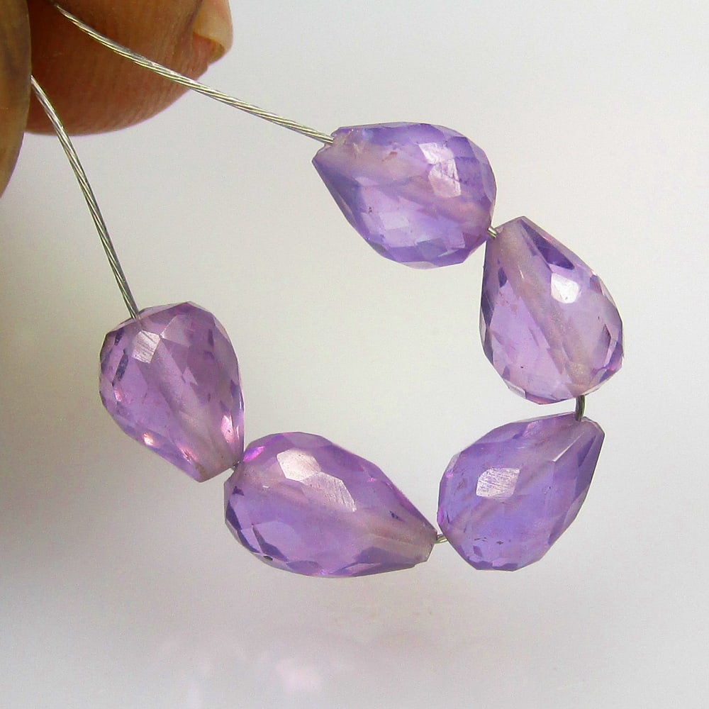 4.22 Ctw Natural 5 Drilled Purple Amethyst Pear Drop Beads: No Reserve! Title: 4.22 Ctw Natural 5 Drilled Purple Amethyst Pear Drop Beads Stone Clarity: Transparent Gemstone:Natural Amethyst Beads Carat Weights: 4.22 Size/Dimensions: 6.2x4.5 - 7.3x4.8 mm / 5 P