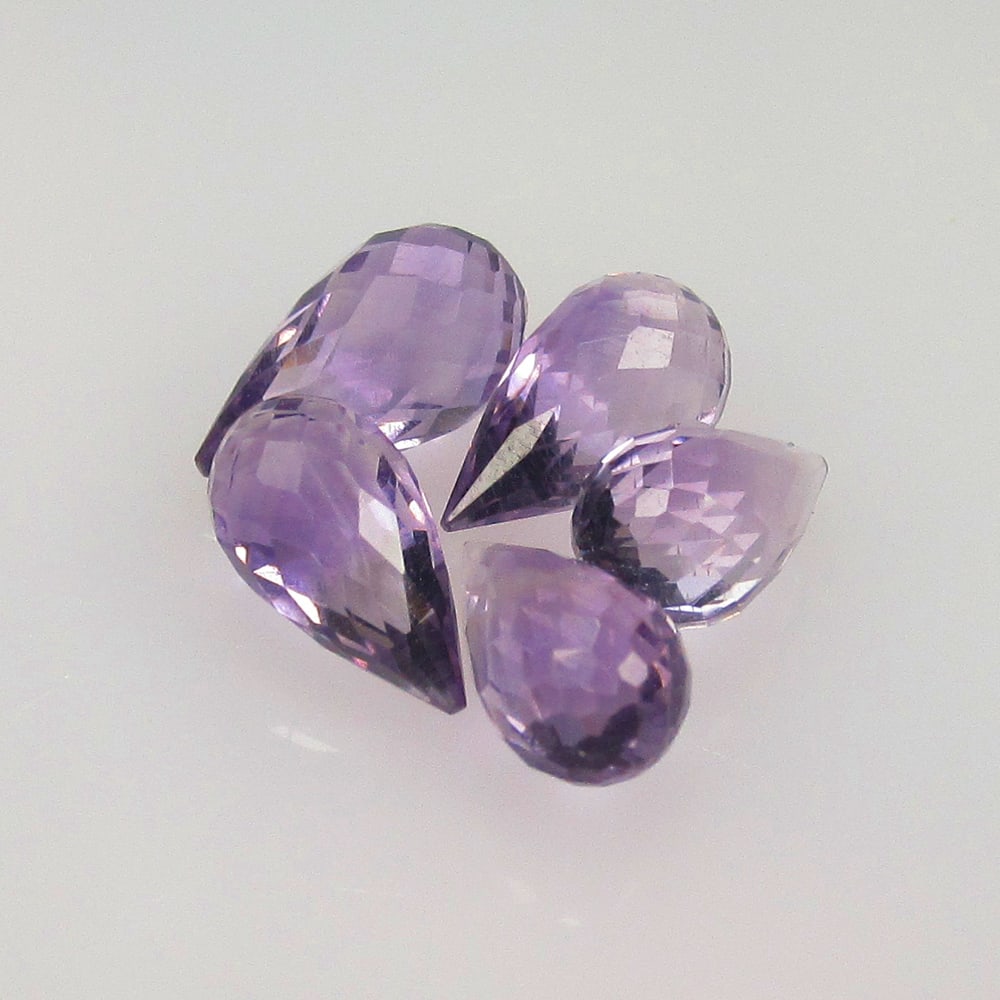 6.17 Ctw Natural 5 Drilled Purple Amethyst Pear Drop Beads: No Reserve! Title: 6.17 Ctw Natural 5 Drilled Purple Amethyst Pear Drop Beads Stone Clarity: Transparent Gemstone:Natural Amethyst Beads Carat Weights: 6.17 Size/Dimensions: 8.5x4.8 - 9.5x5.3 mm / 5 P