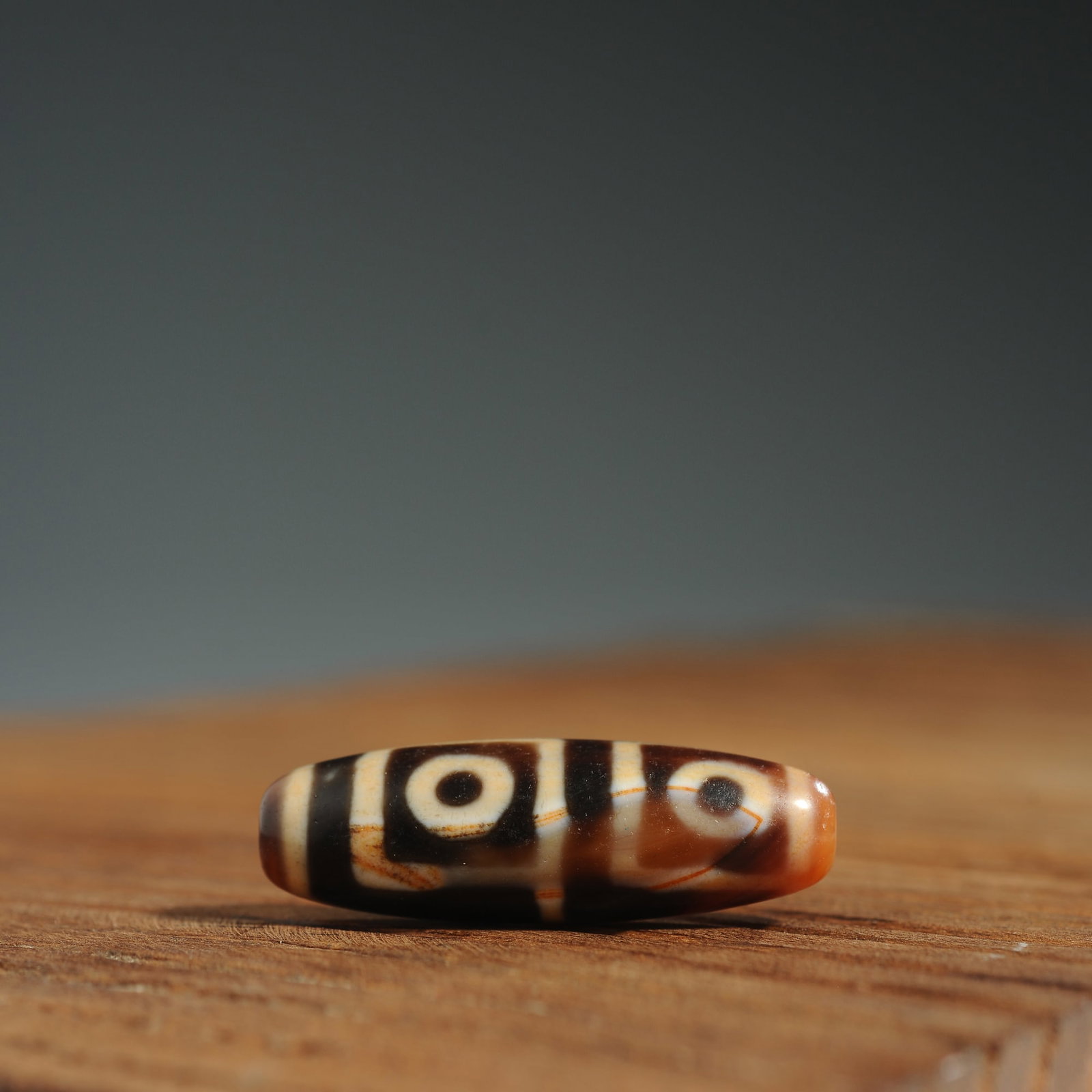 Tibetan four-eye agate dzi bead: Title: Tibetan four-eye agate dzi bead Origin: Asian private collection Date/Period: 20th C Description: Size: Beads about 38x12 mm Tibetan antique agate dzi bead. Agate beads have circular horseshoe