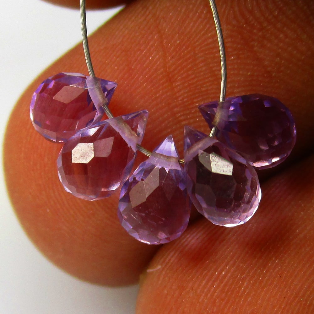 3.24 Ctw Natural 5 Drilled Purple Amethyst Pear Drop Beads: No Reserve! Title: 3.24 Ctw Natural 5 Drilled Purple Amethyst Pear Drop Beads Stone Clarity: Transparent Gemstone:Natural Amethyst Beads Carat Weights: 3.24 Size/Dimensions: 5.9x4.4 - 6.7x4.7 mm / 5 P
