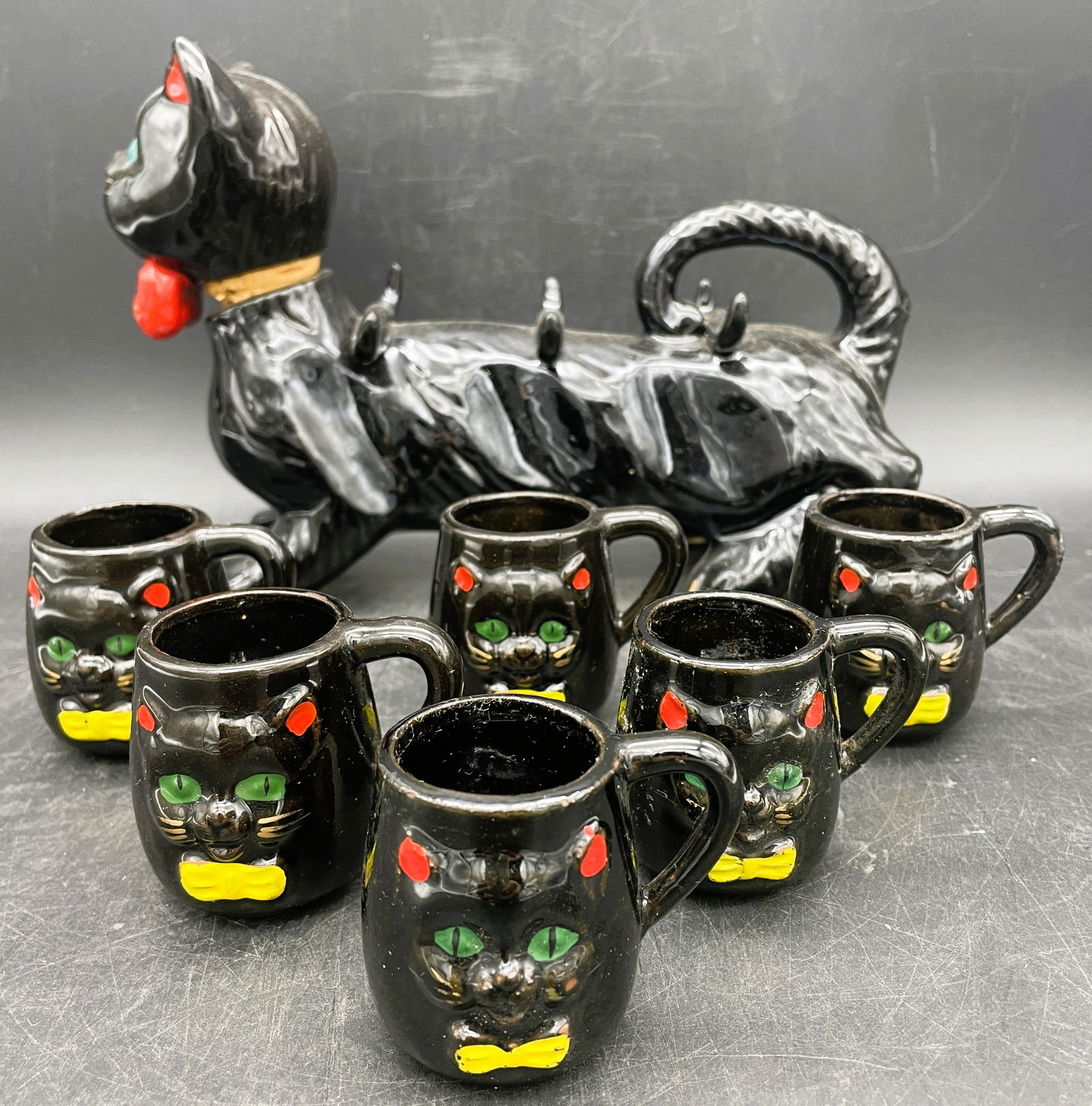 Vintage Redware Decanter Cat with 6 Glasses Japan: Title: Vintage Redware Decanter Cat with 6 Glasses Japan Date/Period: approx 1950's Dimension: approx 9" long x 6" Material: ceramic Additional Information: Vintage Redware Decanter Cat with 6 Glasses