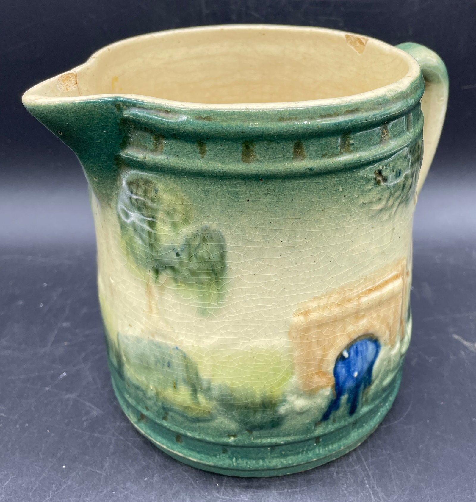 ROSEVILLE POTTERY 1910-16 EARLY WARE GREEN BRIDGE PITCHER: Title: ROSEVILLE POTTERY 1910-16 EARLY WARE GREEN BRIDGE PITCHER Date/Period: 1910-1916 Dimension: 7 x 5.5 x 4.5 Material: pottery Additional Information: ROSEVILLE POTTERY 1910-16 EARLY WARE GREEN BR