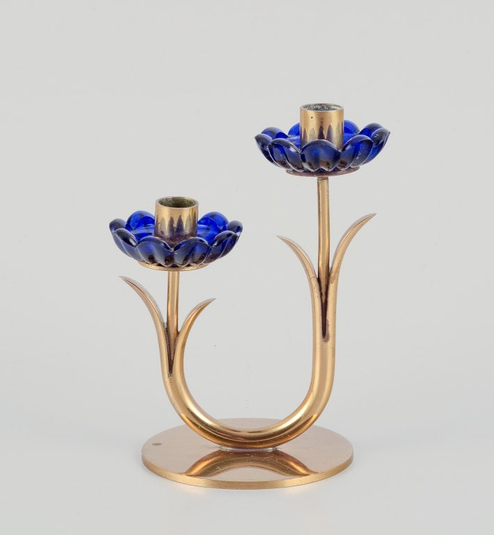 Gunnar Ander for Ystad Metall, Sweden. Candlestick holder in brass and blue art glass shaped like: Title: Gunnar Ander for Ystad Metall, Sweden. Candlestick holder in brass and blue art glass shaped like flowers. For two candles. Description: Gunnar Ander for Ystad Metall, Sweden. Candlestick holde