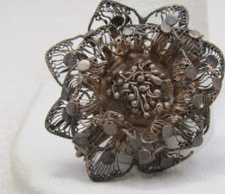 Vintage .800 Silver Filigree Floral Brooch, 1": Vintage .800 Silver Filigree Floral Brooch, 1" with filigree pointed petals and a tiered design. This has seen better days - it does have some damage but wearable. Age is appx. 1920's-1930's. Two of t