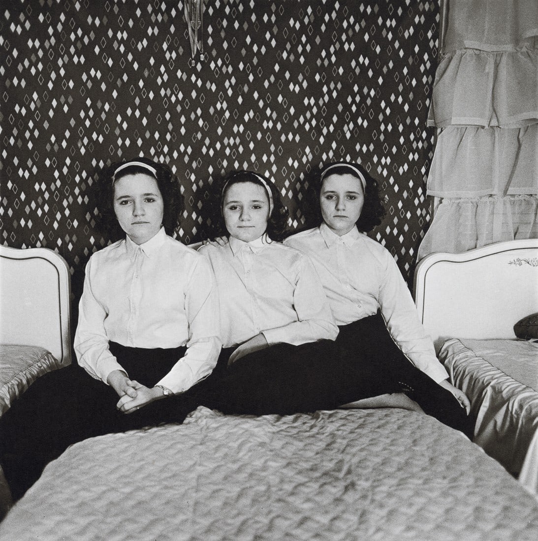 DIANE ARBUS - Triplets in Their Bedroom, NJ, 1963: Artist: Diane Arbus Title: Triplets in Their Bedroom, NJ, 1963 Medium: Photo Litho, 1972, USA Dimensions: 8.3x8.35" Description: Heat Wax Mounted on 11x14" Conservation Board Artist Bio: Diane Arbus w