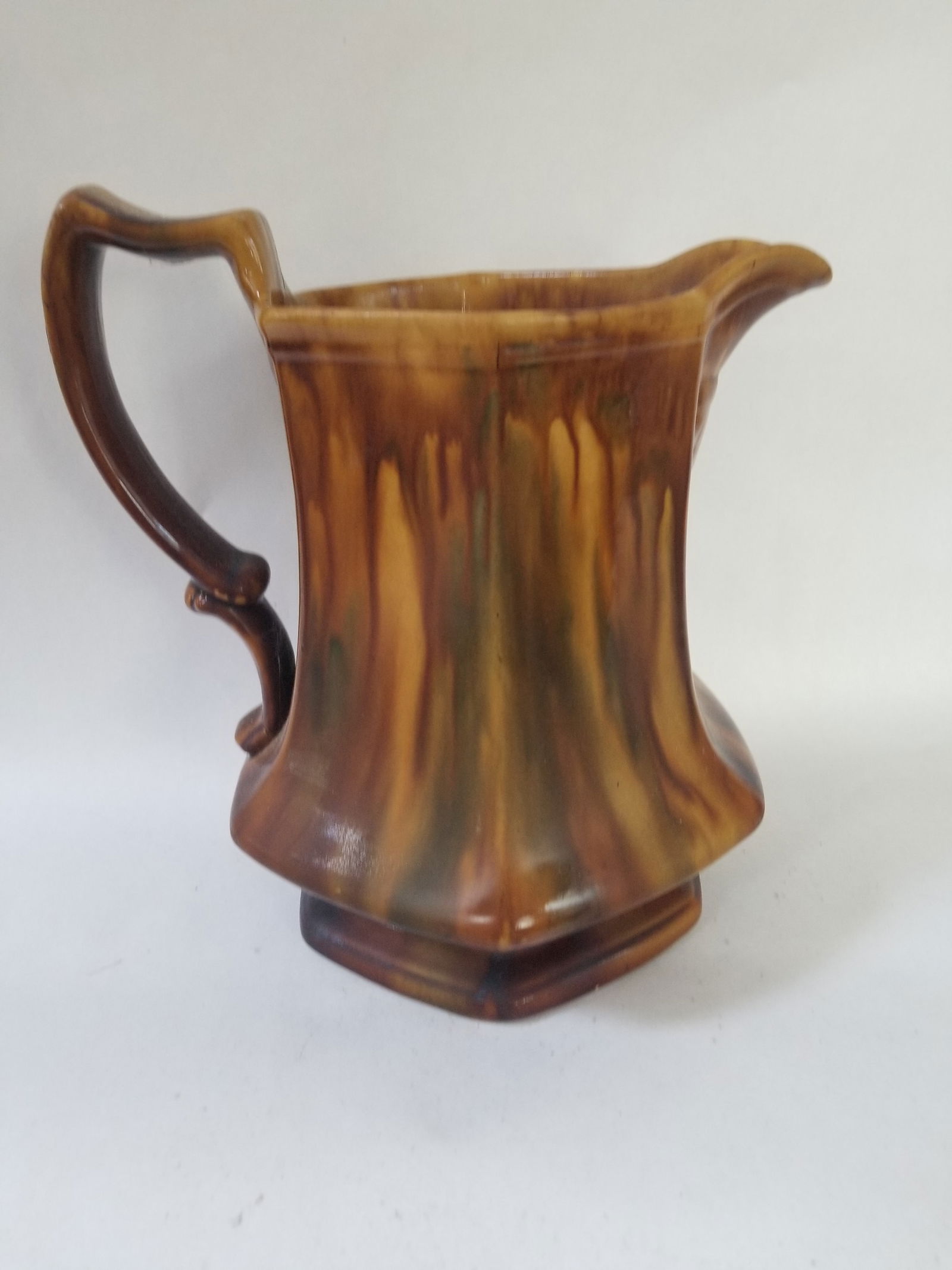 New Jersey yellowware pitcher with Rockingham and teal glaze: C. 1870s. Shown is where it got a knock and a few lines as a result, a few minute flakes. It's solid. 11" to top of handle. Shipping: Domestic: Flat-rate of $18.00 to anywhere within the contiguous U.