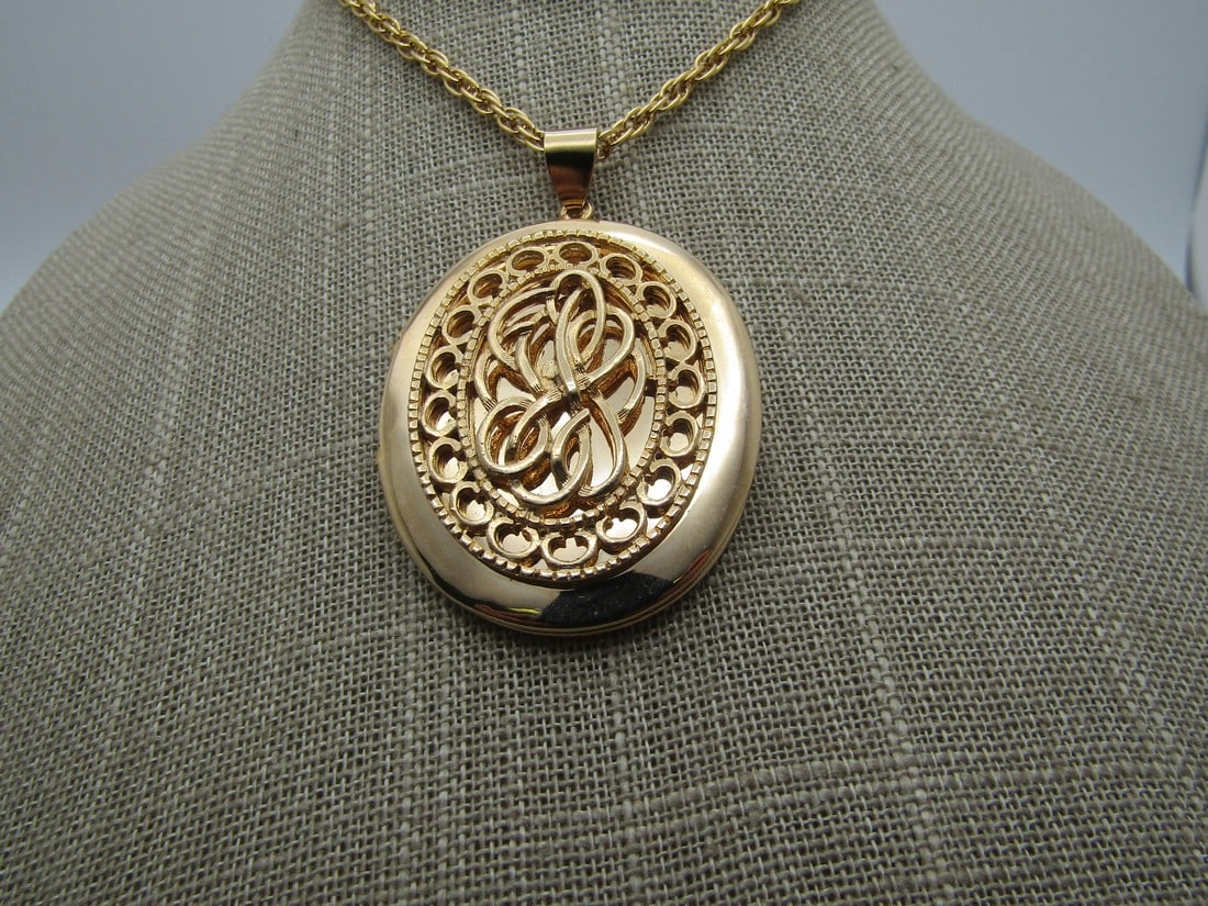 Vintage Filigree Locket Necklace, 24" 1960's-1970's.: Vintage Filigree Locket Necklace, 24" 1960's-1970's. The locket has a filigree frame and a swirled center. The locket is oval and appx. 2.25" tall and 1.5" wide, hinged on the left and will hold two p