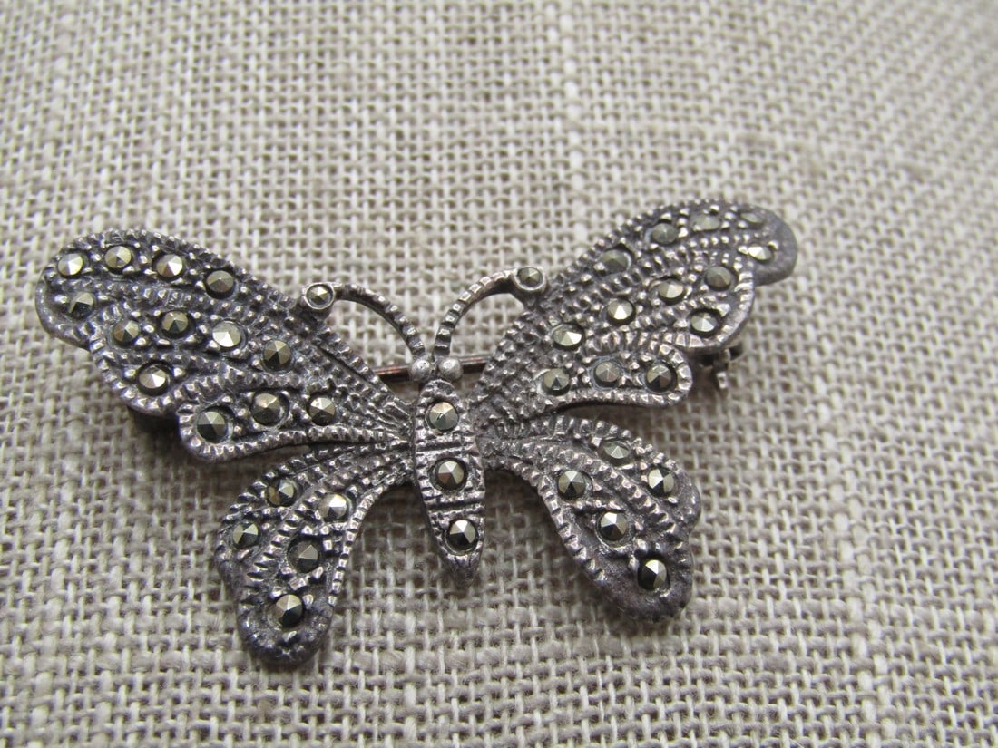 Vintage Sterling Marcasite Butterfly Brooch, 1980's: Vintage Sterling Marcasite Butterfly Brooch, 1980's. It is appx. 1.75" wide and 1" tall with marcasites throughout. Locking clasp. Tests as sterling with a weight of appx. 5.80 gr. It is not signed by