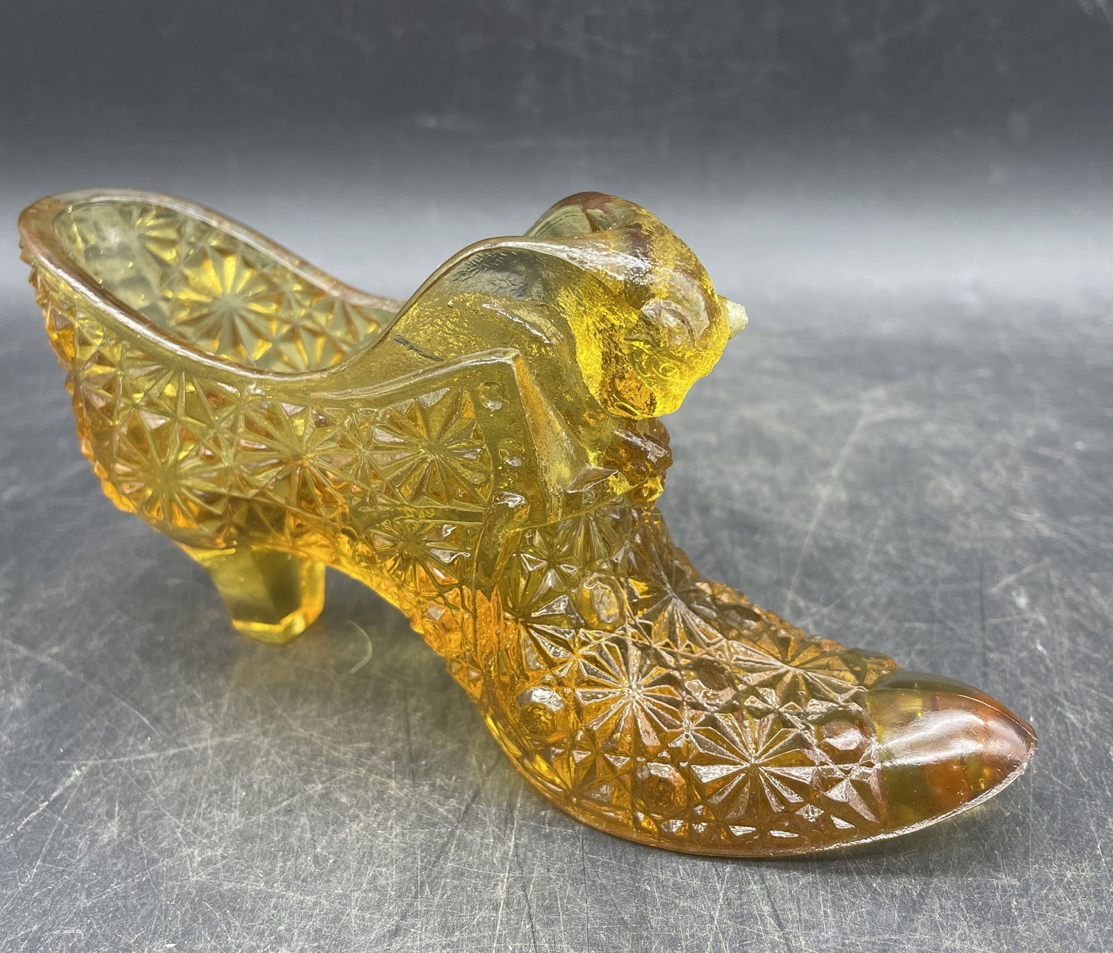 VINTAGE FENTON AMBER GLASS CAT HEAD SHOE BOOT DAISY & BUTTON PATTERN: Title: VINTAGE FENTON AMBER GLASS CAT HEAD SHOE BOOT DAISY & BUTTON PATTERN Date/Period: unknown Dimension: approx 3 x 6 x 1.5 Material: glass Additional Information: VINTAGE FENTON AMBER GLASS CAT HE