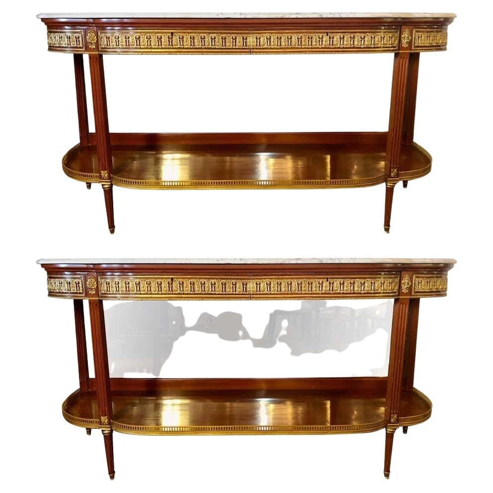 Pair of Louis XVI Jansen Style Console Tables or Sideboards: A fine pair of Louis XVI Jansen style marble-top console tables or sideboards with bevel mirror back panels. This pair of Maison Jansen style demilune form console tables are not only impressive in si