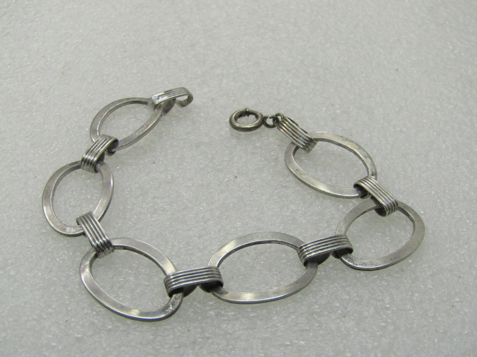 Vintage Sterling Oval Link Bracelet, 7", 1950's-1960's: Vintage Sterling Oval Link Bracelet, 7", 1950's-1960's, 5/8 tall links with ridged 3mm wide ridged connector links. Spring clasp - the older style that is had a wider end but not a thumb tab. Good con