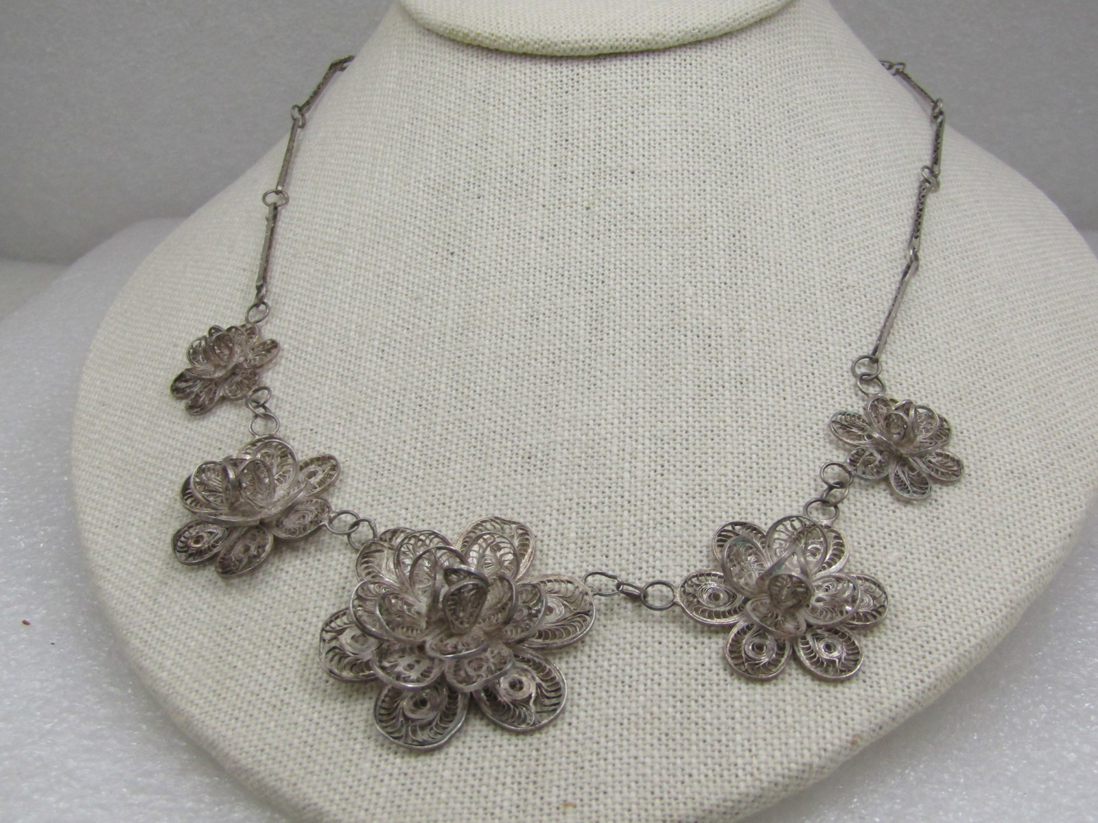 Vintage .800 Silver Floral Filigree Necklace, 18.5", 1940's: Vintage .800 Silver Floral Filigree Necklace, 18.5", 1940's. Five graduated filigree floral blossoms 3-D design on top with the largest at center at 1.5" and the smallest at 3/4". Filigree bar links w