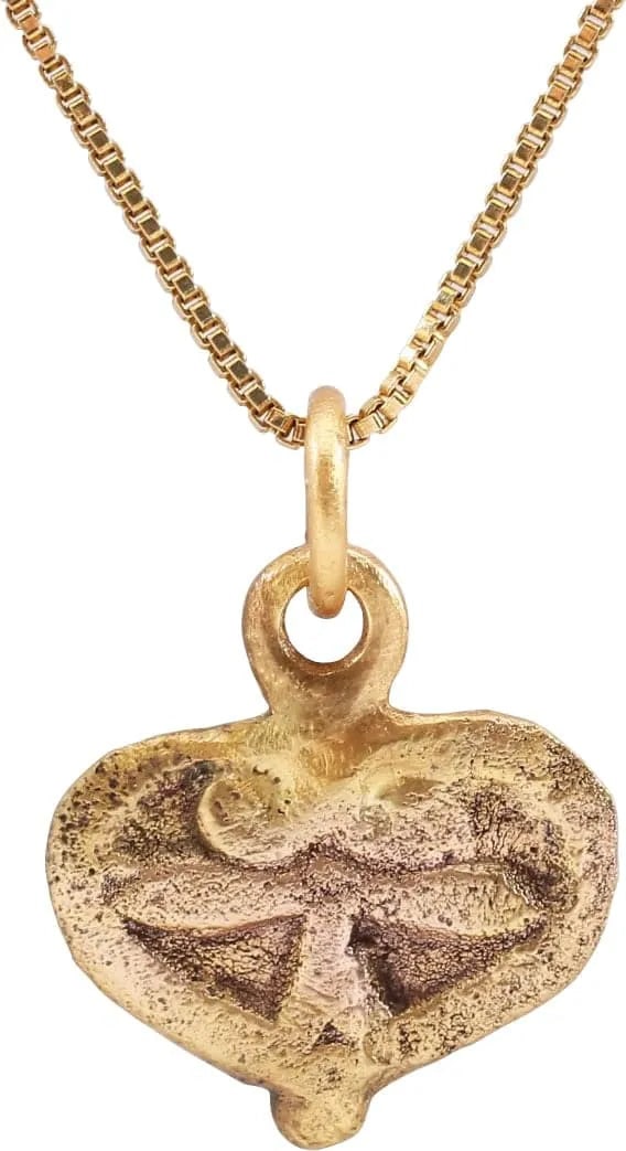 FINE VIKING HEART PENDANT NECKLACE, 10TH-11TH CENTURY AD: Just over 5/8" width. Broad heart with broad borders forming the top cusp and extending into the field as scroll terminals over the raised trefoil. Made by the open face mold technique. The heart stoo