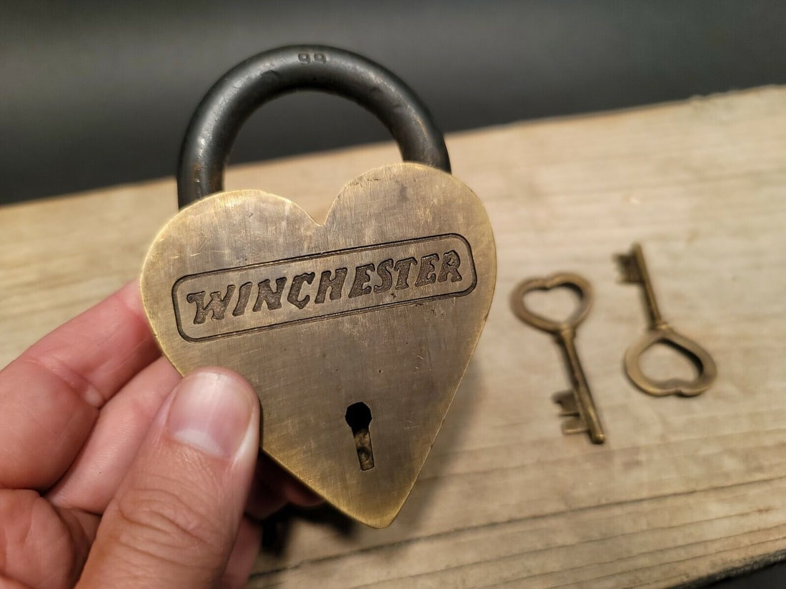 Brass Heart Winchester Firearms Ammo Box Padlock Lock: 3" tall x 4 1/4" Wide Nice reproduction brass winchester padlock! This lock is fully functional! Hard to tell its age. Heavy iron and brass. Great aged patina throughout. Limited quantity available! R