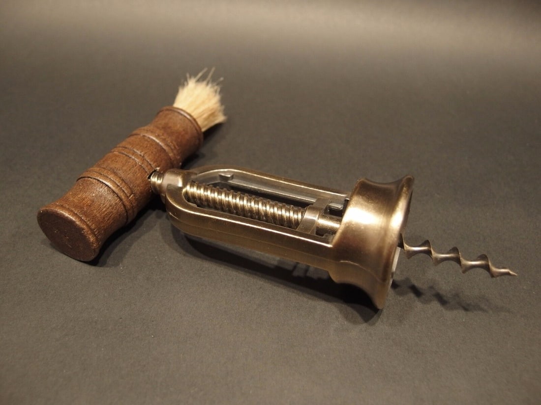 Open Frame Corkscrew w Brush Wine Bottle Opener: 6 1/4" Long max x 4 1/2" Wide Antique reproduction open frame mechanical bristle brush corkscrew. The handle is hardwood, the shaft and worm are steel. The frame is likely cast brass or zinc due to th