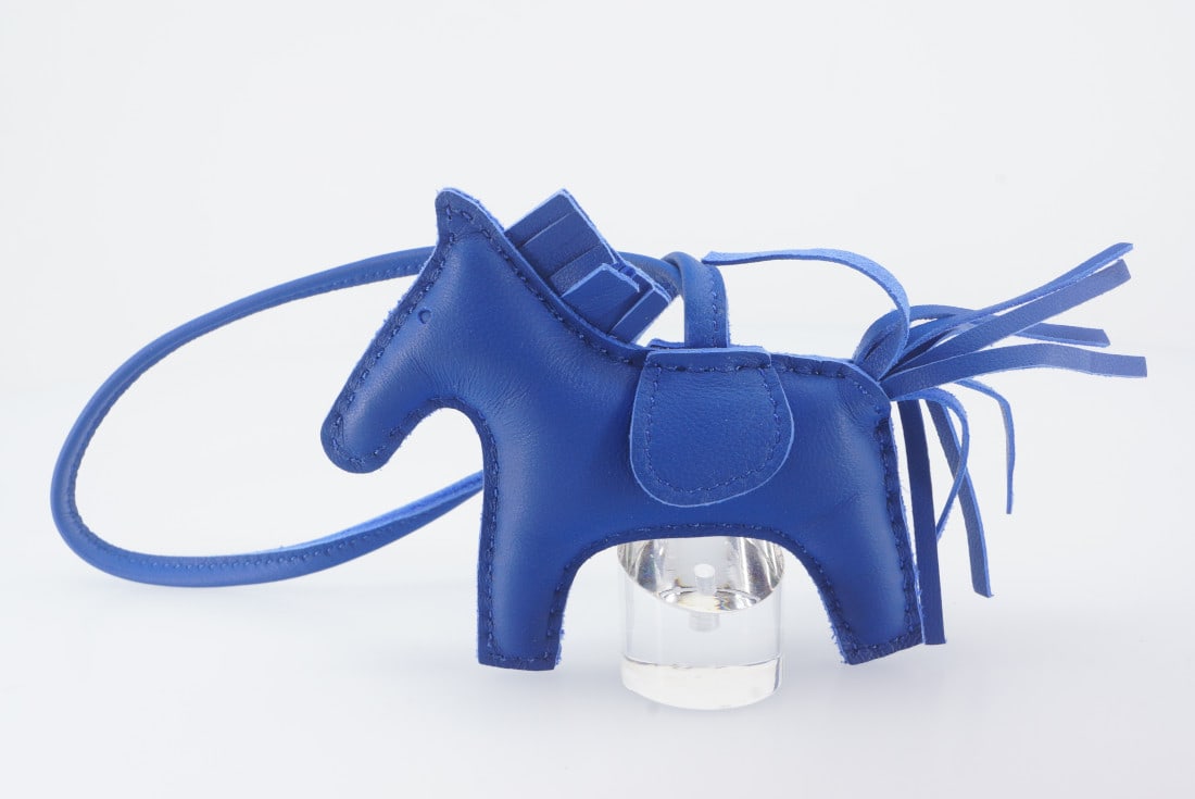 Hermes Bag Charm - Rodeo Charm 3 (Bleu de France) - New: Title: Hermes Bag Charm - Rodeo Charm 3 (Bleu de France) - New Materials: Leather Description: Specifications Brand: HermÃ¨sÂ® Object: Bag Charm Model: Milo Lambskin Grigri Rodeo Horse Bag Charm Y