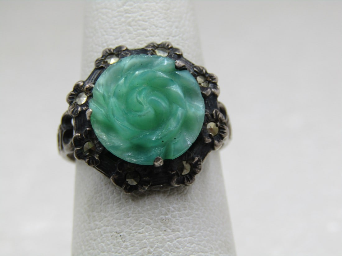 Art Deco Carved Peking Glass Rose Marcasite Ring, Sz. 5.25, Sigined Uncas: Art Deco Carved Peking Glass Rose Marcasite Ring, Sz. 5.25, Sigined Uncas. Carved rose blossom that is appx. 12mm round with a floral frame around the glass each with a marcasite in the blossom. Signe