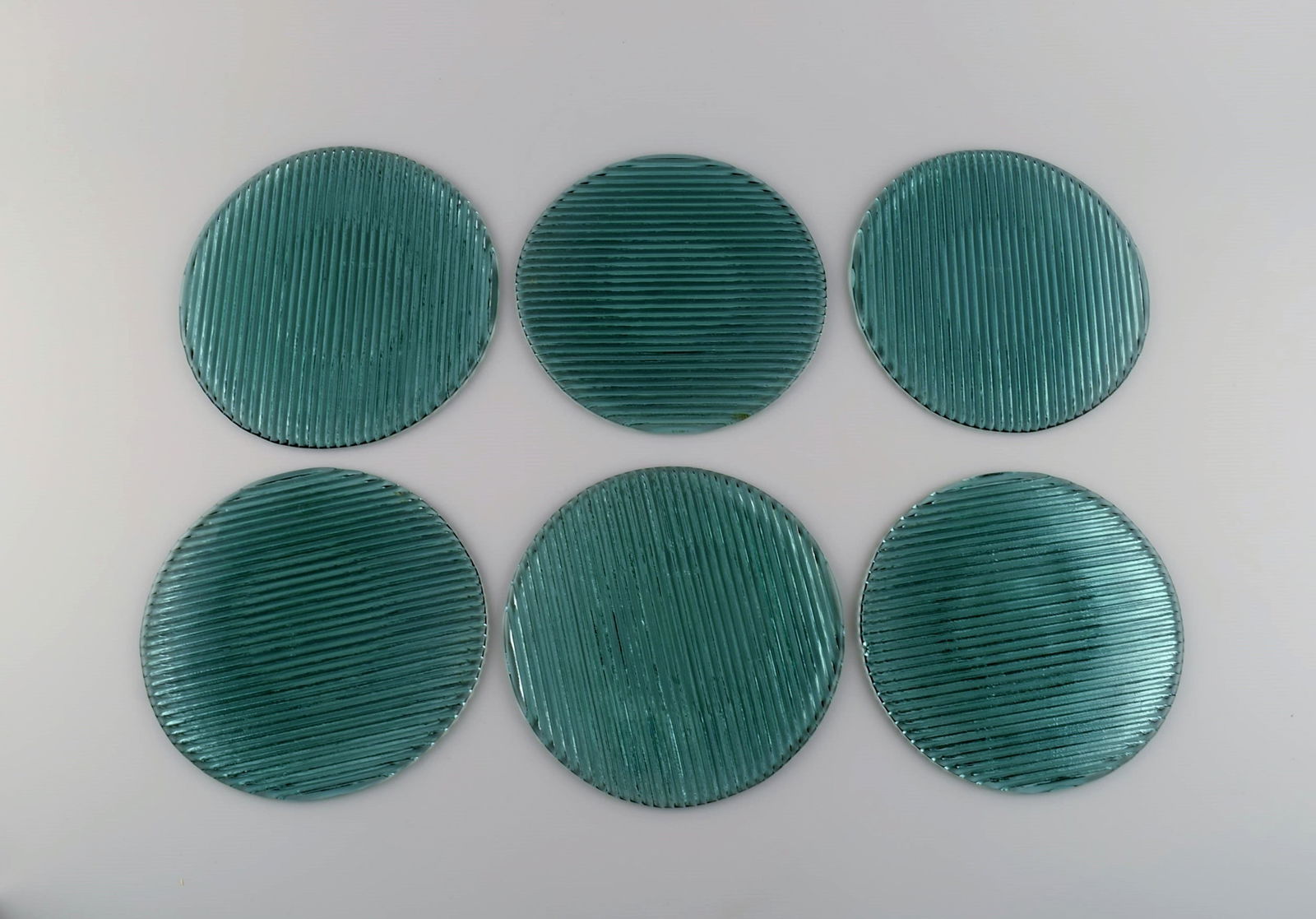 Per Lütken for Holmegaard. Six "Buffet" plates in blue-green mouth blown art glass. 1980s.: Per Lütken for Holmegaard. Six "Buffet" plates in blue-green mouth blown art glass. 1980s. Diameter: 18 - 19 cm. In excellent condition. Reserve: $175.00 Shipping: Domestic: Shipping rates are de