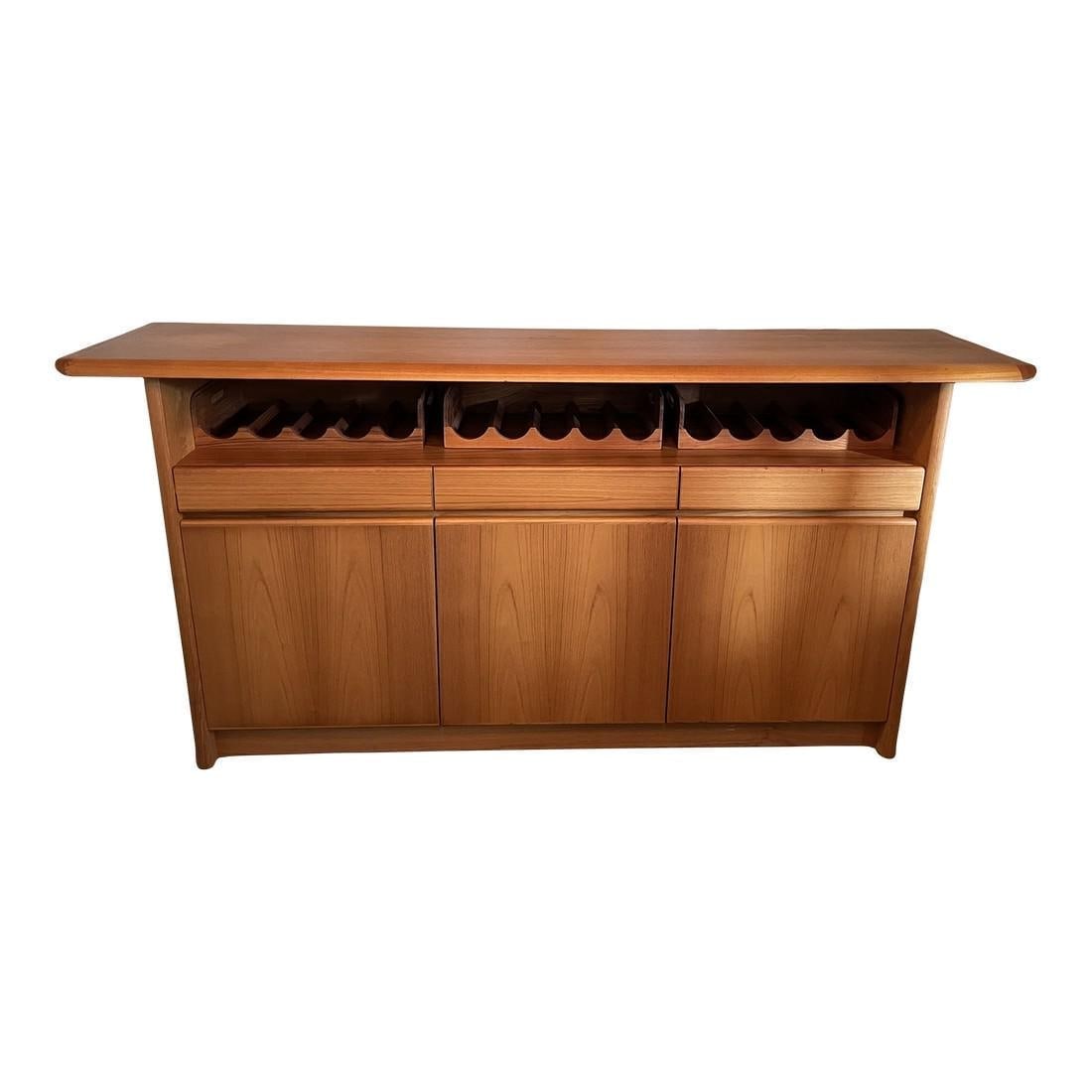Mid Century Danish Side Board With Wine Racks: This is a super versatile mid century Danish sideboard with removable wine racks. Have your linens and silverware at the ready with this lovely piece. DIMENSIONS: 75"W " 17.25"D " 37"H STYLES: Mid-Cen