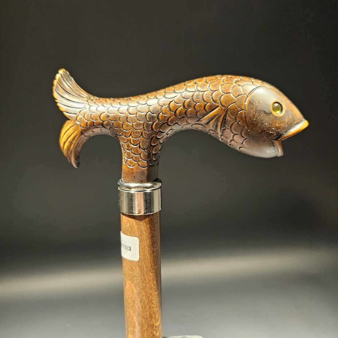 36" Italian Trout Head Walking Stick Cane: 36" Long 3/4" shaft Appearance: The handle is derby-shaped, brown with a wood-tone finish, and has a full fish design with glass eyes and a brass ring. Material: The handle is made from cellulose acet