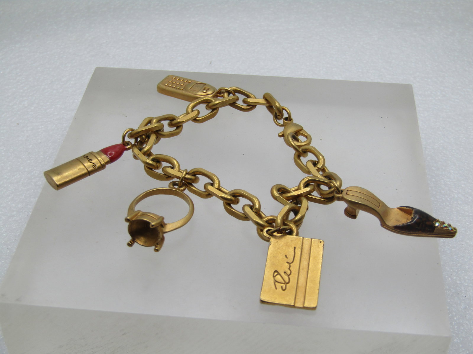 Vintage Glamour Charm Bracelet, 2000's, 7.75", 5 Charms: Vintage Glamour Charm Bracelet, 1990's-2000's, 7.75", 5 Charms: Engagement Ring; Cell Phone; Enameled Lipstick; Credit Card with Rhinestone; Enameled & Rhinestone Open Back Heels. Satiny gold tone fin
