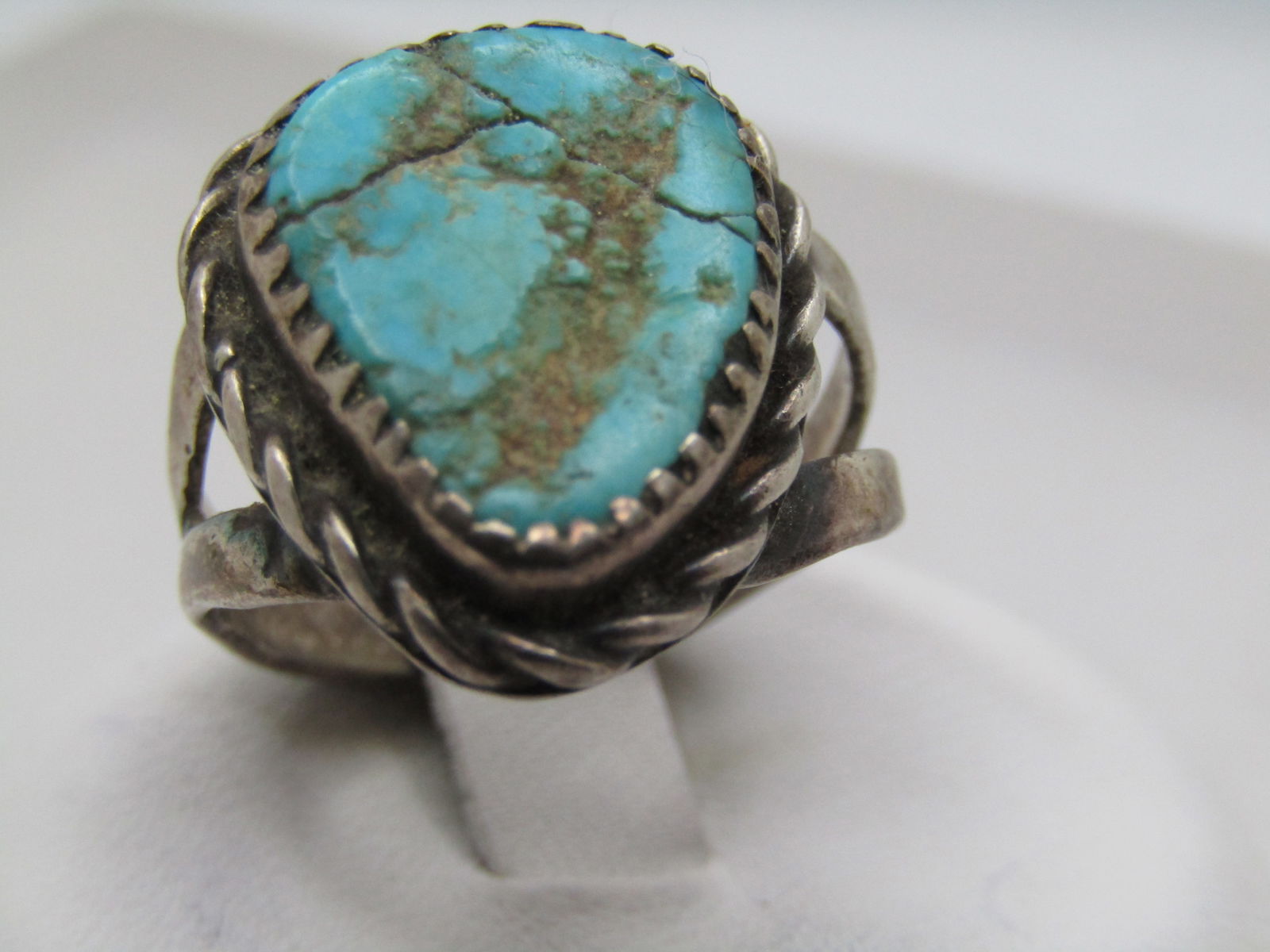 Vintage Sterling Southwestern Turquoise Ring, Sz. 6.75, 1950's-1960's: Vintage Sterling Southwestern Turquoise Ring, Sz. 6.75, 1950's-1960's. Unisex. Old pawn, unsigned. Tests as sterling with a weight of appx. 5.75 gr. This has a triangular turquoise stone that is appx.