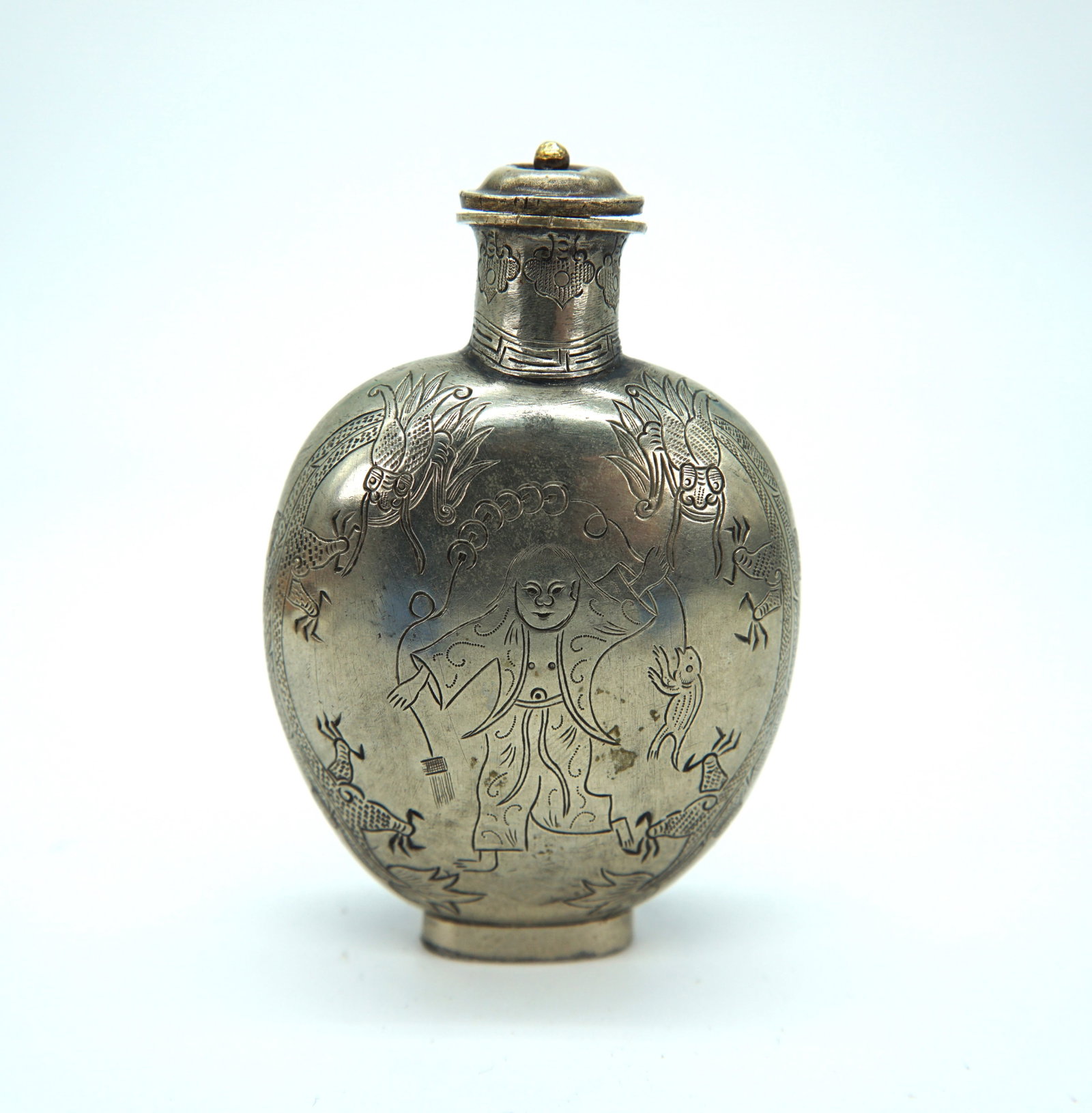 56-01 Rare Silver Snuff Bottle Carved with Liu Hai, the Golden Toad with Coins, and Flying Dragons: Title: 56-01 Rare Silver Snuff Bottle Carved with Liu Hai, the Golden Toad with Coins, and Flying Dragons Origin: China Date/Period: 19th Century Materials: Silver or Copper Size: H:3.7";W:1.8". Descr
