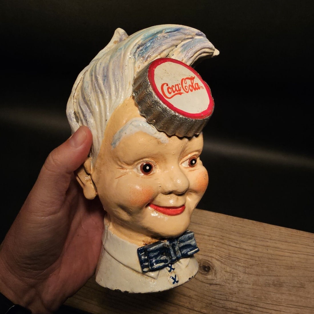 Cast Iron Sprite Boy Coin Bank: 7" Tall 5" Wide Wonderful cast iron sprite boy coin bank doll head. As you can see this coin bank looks like an original! See the images for the best details. Such a neat collectible! Reserve: $35.00 