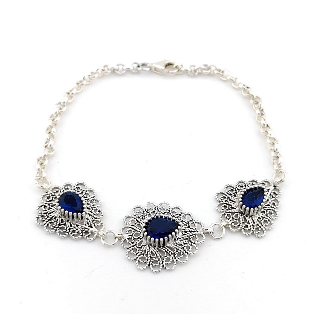 925 Silver Filigree Ladies Bracelet ornated with Blue Zircons: Title: 925 Silver Filigree Ladies Bracelet ornated with Blue Zircons Description: 925 Silver Filigree Ladies Bracelet ornated with Blue Zircons -Condition:New Weight:9.1g -Size:Adjustable max size 7.8