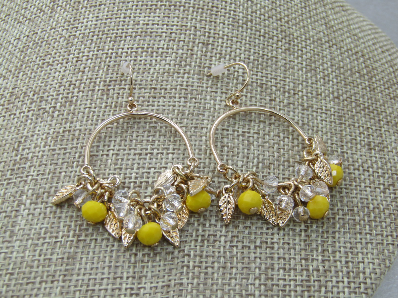 Avon Lemon Hoop Pierced earrings, New in Box, Unworn: Avon Lemon Hoop Pierced earrings, New in Box, Unworn, 2" long from bend on hoop to bottom of faceted lemon yellow beads that dangle at the bottom of the hoop along with leaf dangles. This has an arche