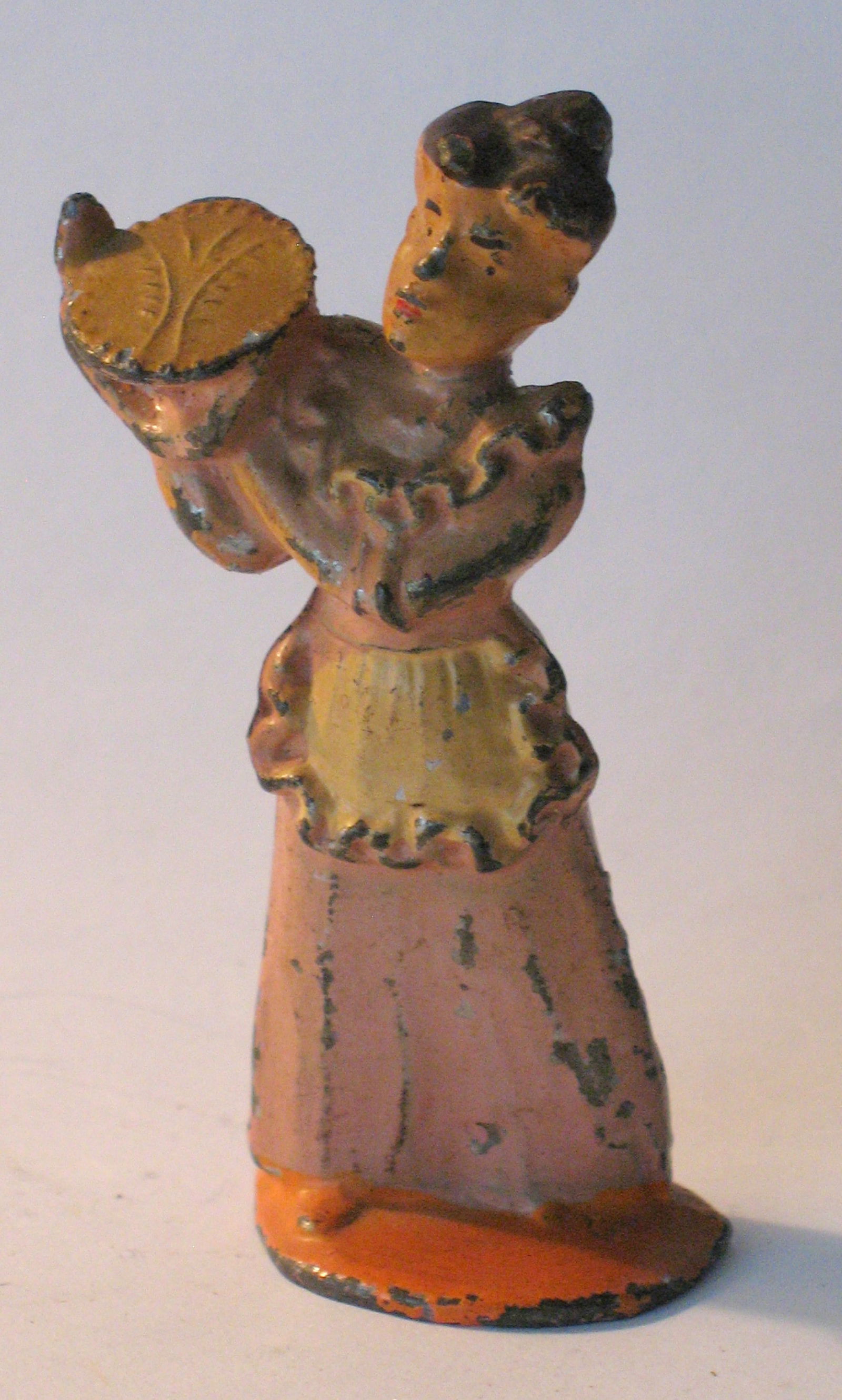 Antique cast metal Woman with her pie. (1 of 3)