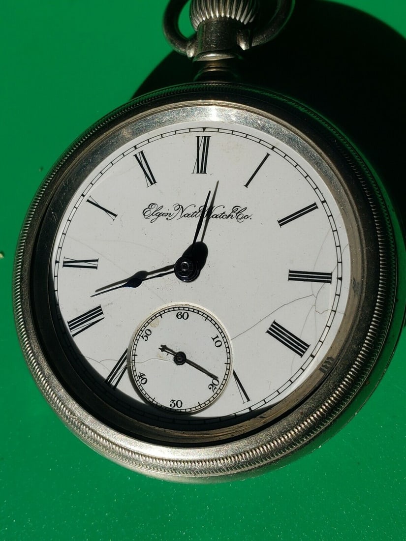 antique pocket watch cresent drop out case elgin national watch co.: Great looking piece in very good condition. NOT WORKING. Crack in face. balance wheel moves freely. Missing back . Not sure if coin silver. Holds 1 3/4" works. Dates to 1910. Shipping costs include in