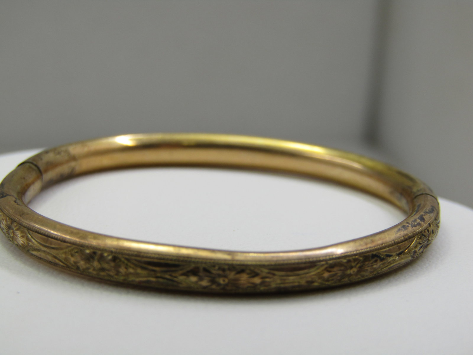 Victorian 12kt G.F. Infant/Toddler Slide Bangle Bracelet 4.5": Victorian 12kt G.F. Infant/Toddler Slide Bangle Bracelet, Thumb tab opens bracelet where it is signed L Mfg. 1/10 12kt . Slide mechanism with thumb tab to o pen. 1800's. 4mm wide withetched design aro