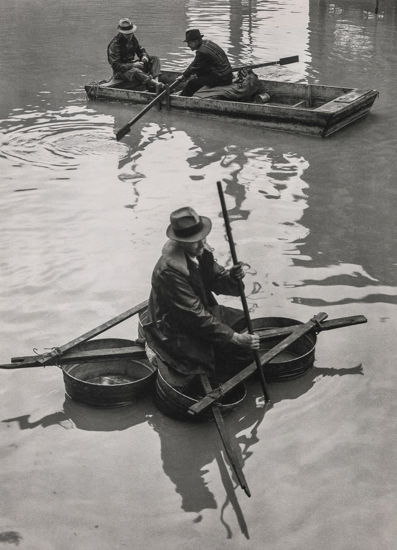 MARGARET BOURKE-WHITE - Flood Victim in Washtub Boat: Artist: Margaret Bourke-White Title: Flood Victim in Washtub Boat, 1937 Medium: Photo Litho, 1998, Italy Dimensions: 6.15x8.5" Description: Heat Wax Mounted on 8.5x11" Conservation Board Artist Bio: M
