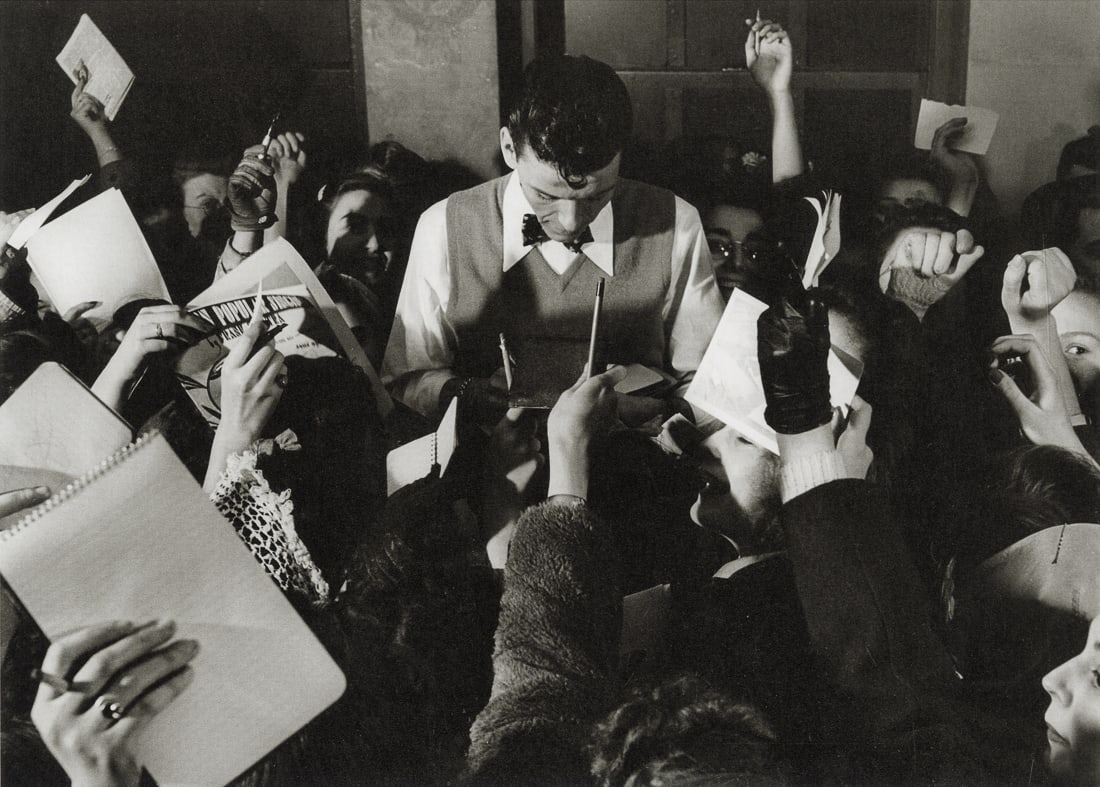 SAM SHAW - Frank Sinatra Signing Autographs,1940s: Artist: Sam Shaw Title: Frank Sinatra Signing Autographs For Fans After A Concert, Mid-1940s Medium: Photo Litho, 2010, Germany Dimensions: 8.65x6.2" Description: Heat Wax Mounted on 8.5x11" Conservat