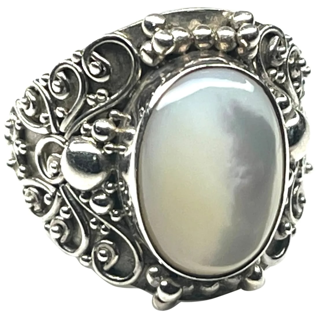 Vintage Oval Mother of Pearl Cabochon Ornate Sterling Siver Ring: Title: Vintage Oval Mother of Pearl Cabochon Ornate Sterling Siver Ring Description: Vintage Oval Mother of Pearl Cabochon Ornate Sterling Siver RingHallmarked 925 BA Indonesia Weighs 9.5 grams.Size 6