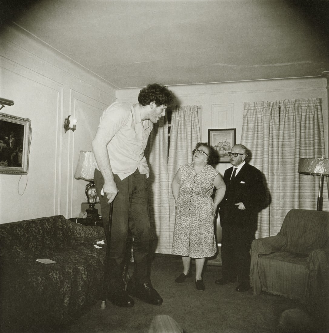 DIANE ARBUS - A Jewish Giant at Home, NY, 1970: Artist: Diane Arbus Title: A Jewish Giant at Home with His Parents in the Bronx, NY, 1970 Medium: Photo Litho, 1997, Italy Dimensions: 8.35x8.45" Description: Heat Wax Mounted on 11x14" Conservation B