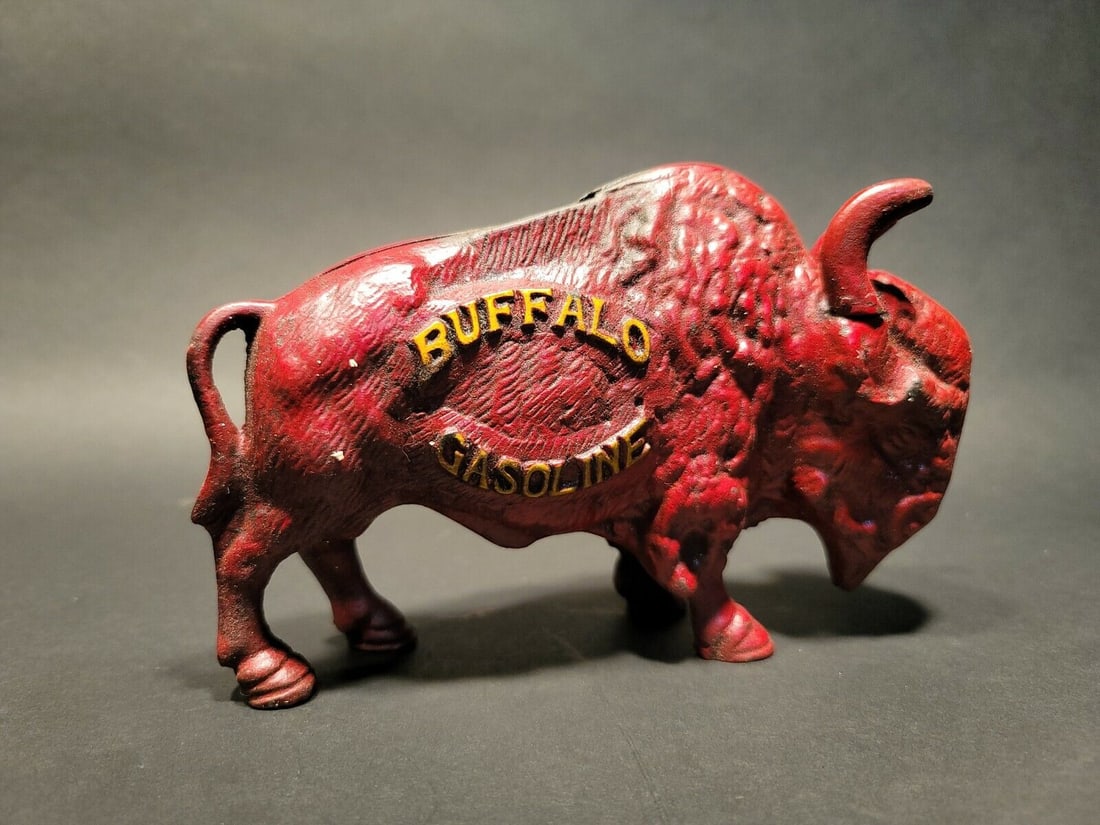 Buffalo Gasoline Cast Iron Coin Bank: 7 1/2" Long x 5" High Great reproduction cast iron Buffalo Gasoline coin bank. This piece was made to look just like an antique, but is actually new. Great aged red paint. Reserve: $45.00 Shipping: Do