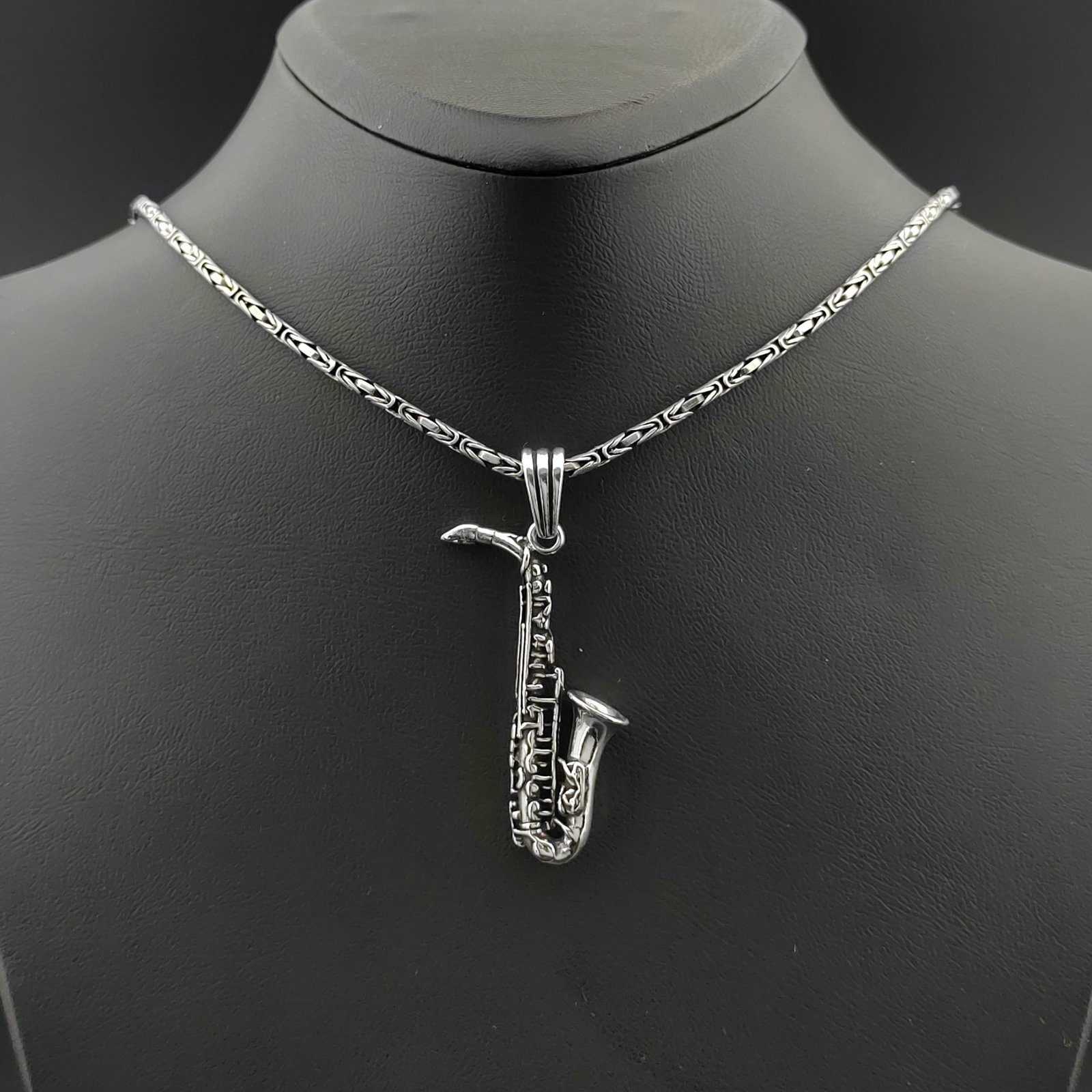 925 Silver Chain with Saxophone Pendant: Title: 925 Silver Chain with Saxophone Pendant Description: 925 Silver Chain with Saxophone Pendant -Total Weight:22.9g Chain Size: 23.62 in(60cm). Pendant Size:0.55x1.92 in (14x49mm) (Bail included).