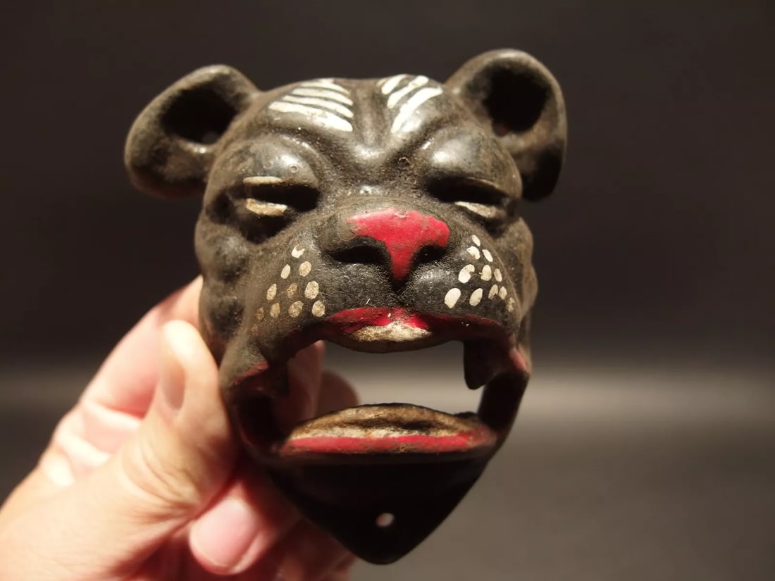 Cast Iron wall mount folk art Bulldog Beer Bottle Opener: 4" Tall x 3 1/2" Wide Such a neat reproduction antique cast iron bulldog wall mounted bottle cap opener. The mouth of the bulldog is where you would open the bottle. Certainly a great accent piece! Be
