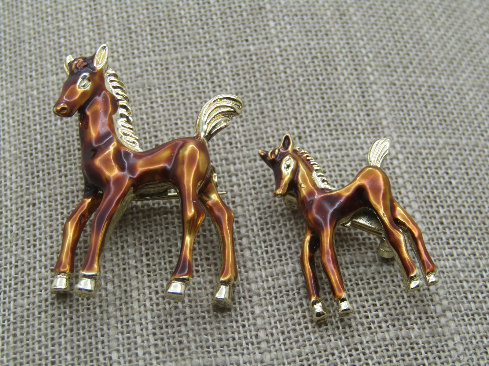 Vintage Pair Enameled Horse & Colt Brooch - Scatter Pins, 1960's: Vintage Pair Enameled Horse & Colt Brooch - Scatter Pins, 1960's. A mare and her colt enameled in a chestnut brown with gold tone hooves, tail, mane, ears, eyes, and nose. gold tone back. They are not