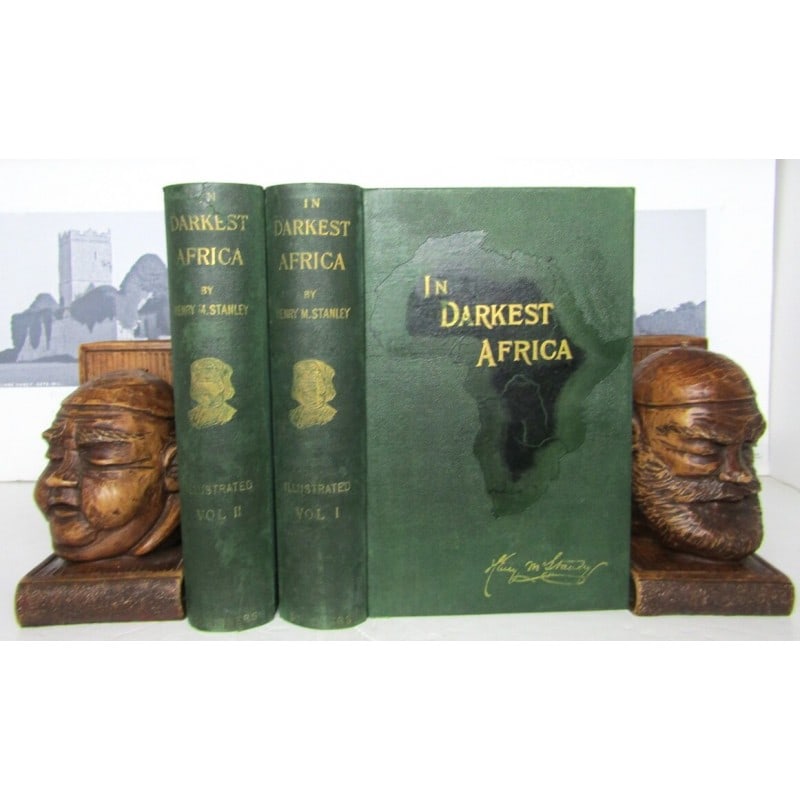 In Darkest Africa: Two volumes. First edition 1890. Publishers original green cloth with embossed map of Africa Gilt title and gilt signature. Gilt title and vignette to spine. VOLUME I. xiv, 547 pages. Frontispiece por