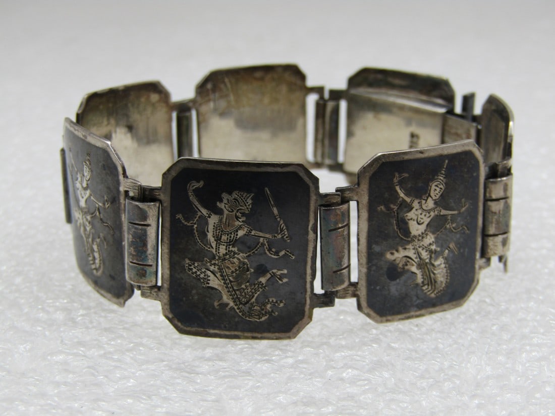 Vintage Sterling Enameled Siam Niello Goddess Bracelet, 6.5": Vintage Sterling Enameled Siam Goddess Bracelet, 6.5" and appx. 21mm wide with seven tiles that are rectangular and cut on the corners with a sterling frame and goddess and black enameling. Age is app