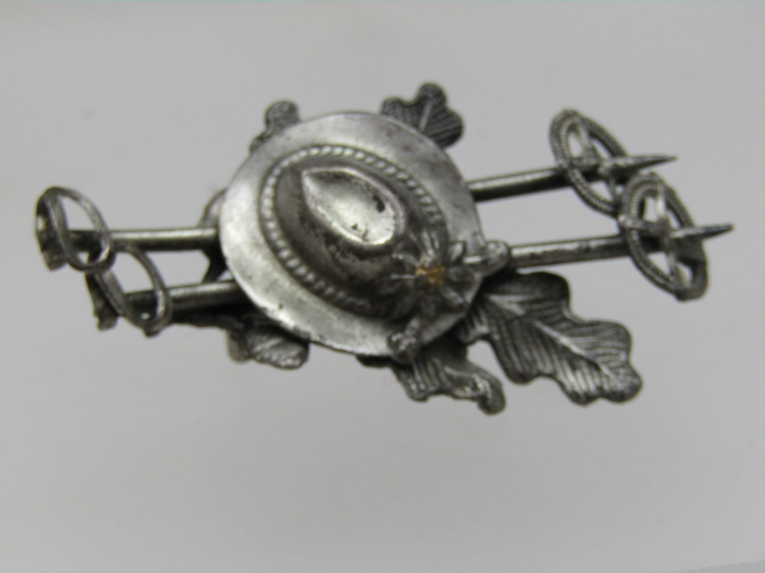 Vintage West Germany Bavarian Hiker Brooch, Mid-Century: Vintage West Germany Bavarian Hiker Brooch, Mid-Century. This is a silver/pewter tone brooch with cross country ski poles under a Bavarian hat with leaves under the hat. Signed Western Germany. 1.1/8"