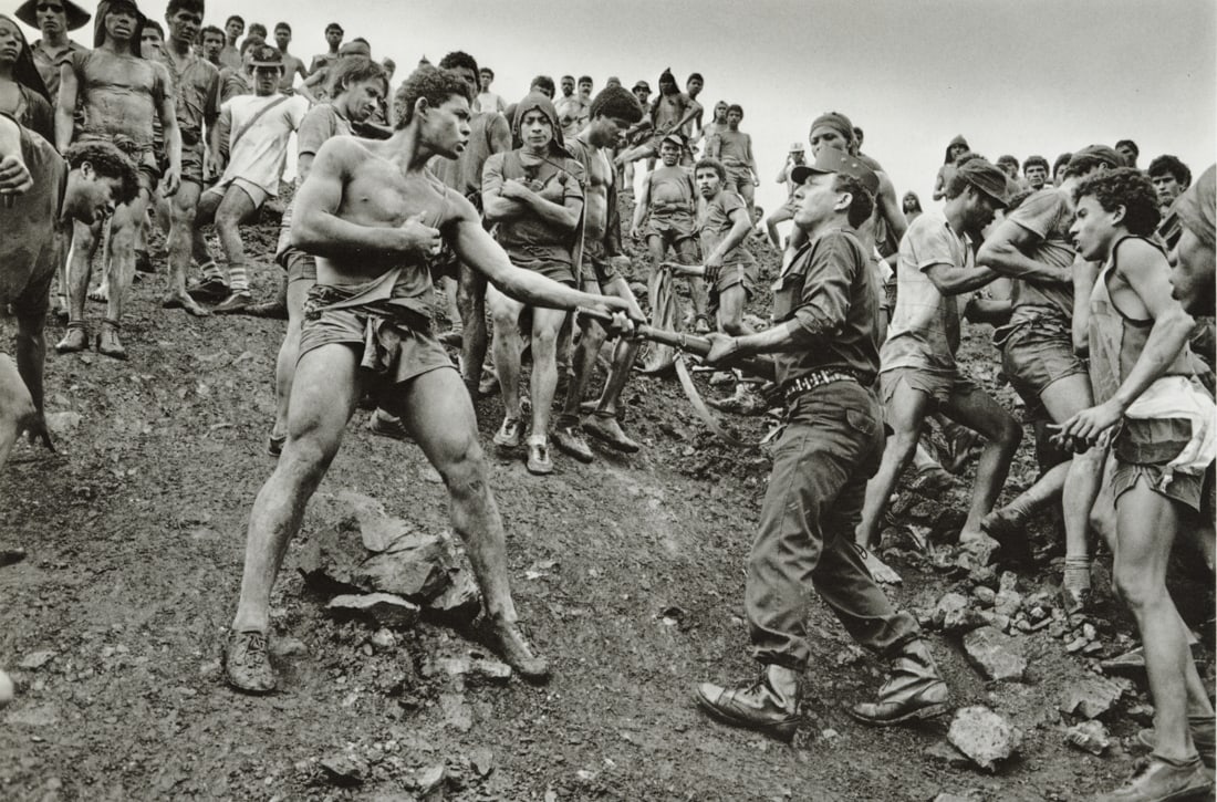SEBASTIAO SALGADO - Dispute Among Workers, Brazil: Artist: Sebastiao Salgado Title: Dispute Among The Workers of The Serra Pelada Gold Mine and a Member of the Military Police, Brazil, 1986 Medium: Photo Litho, 1999, Italy Dimensions: 9x5.95" Descript