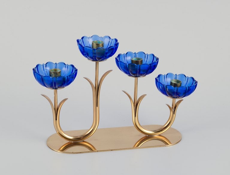 Gunnar Ander for Ystad Metall, Sweden. Candlestick holder in brass and blue art glass shaped like: Title: Gunnar Ander for Ystad Metall, Sweden. Candlestick holder in brass and blue art glass shaped like flowers. For four candles. Description: Gunnar Ander for Ystad Metall, Sweden. Candlestick hold